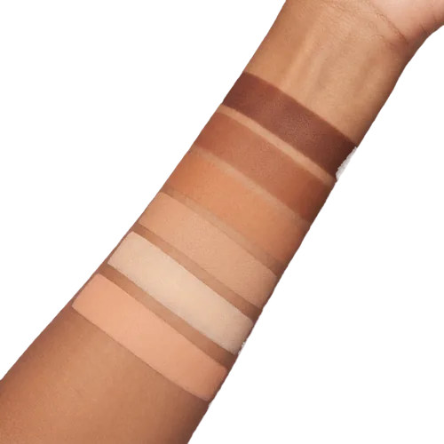 A close-up of skin beside a range of foundation shades with the matching shade selected
